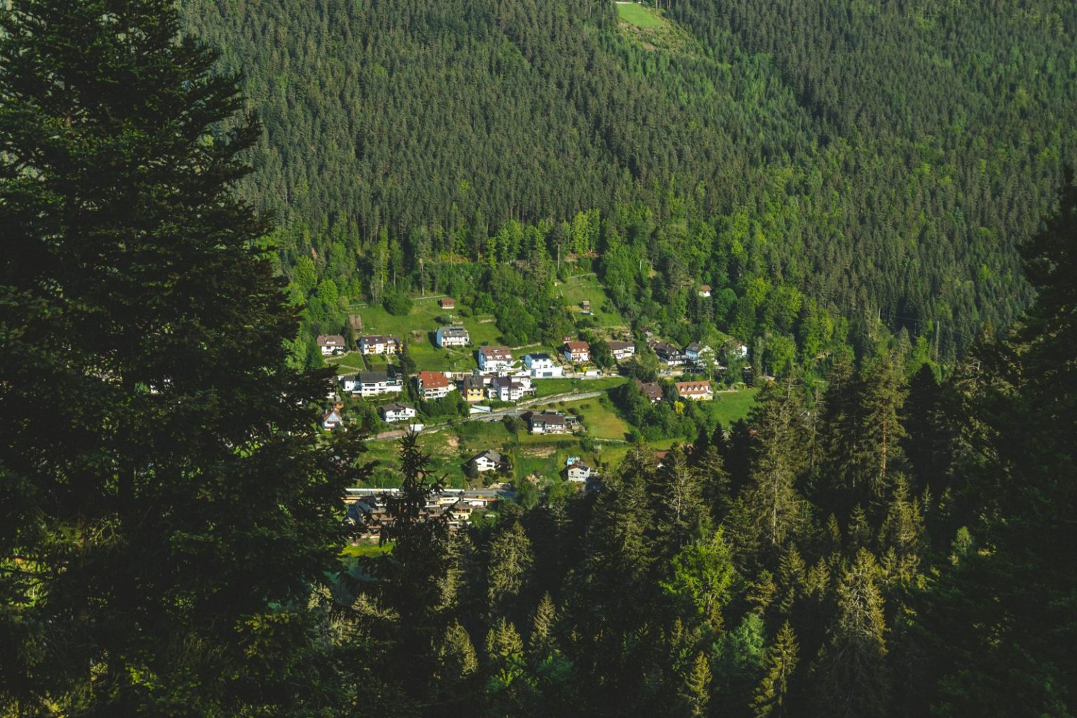 Village in a forested green valley, illustrating a romantic weekend away in the countryside
